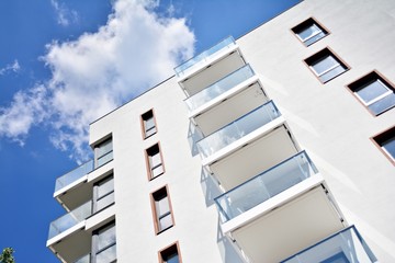 Modern apartment buildings on a sunny day with a blue sky. Facade of a modern apartment building