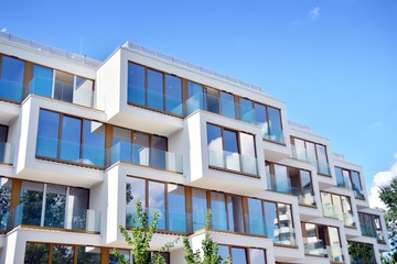 Fototapeta premium Modern apartment buildings on a sunny day with a blue sky. Facade of a modern apartment building