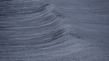 Small surf reaching the beach ahead of the storm