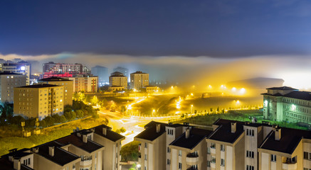 Obraz premium long exposure city when the fog comes under star light