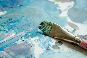 Artist paint brush on the wooden palette