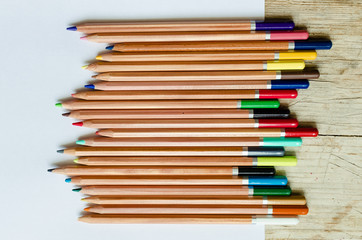 Obraz premium Wooden color pencils on white paper