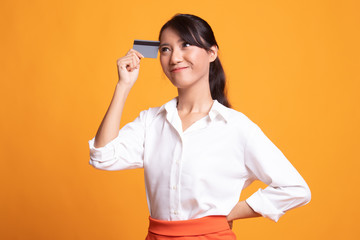 Young Asian woman think with a blank card.