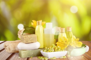 Bottles with organic essential aroma oils on background