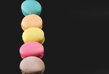 Macarons on a black background