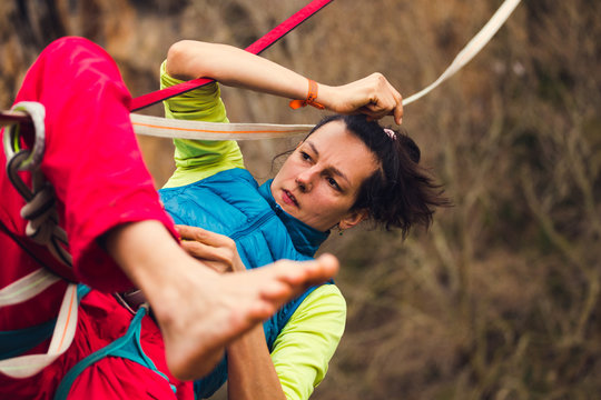 A woman tries to climb the highline.