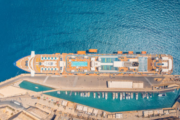 Fototapeta na wymiar Cruise ship parking at marina in blue sea. Aerial view
