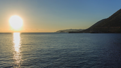 Sunrise over the mountains and the sea.