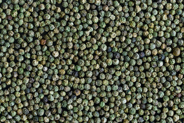 Dried green peppercorns on a dark wooden table. Wallpaper, high resolution