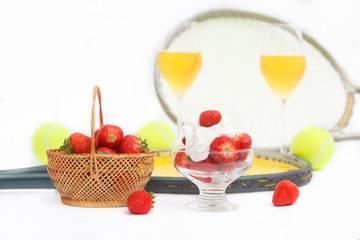 Strawberries with whipped cream, glasses with champagne and  tennis equipment on Wimbledon...