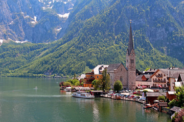 Famous Austria village Hallstatt with church and lake