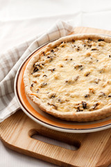 Chicken tart with mushrooms and cheese on a plate