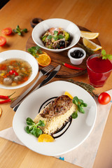 Roasted pork patt with boiled bulgur and greens for lunch in a restaurant