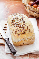 Homemade wheat bread with flax seeds on a kitchen table
