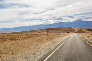 Desert road leading through Death Valley National Park, Artist's Drive road, California USA.