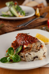 Close up of a steamed fish in tomato gravy with wild boiled rice for diet dinner in a cafe