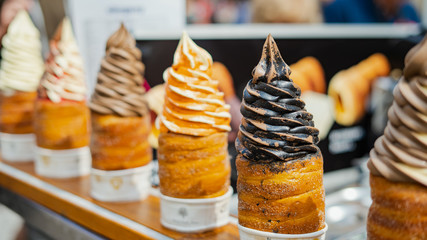  Traditional Tasty Baked Trdelnik with Ice Cream in Czech Republic. Czech bakery baked on the...
