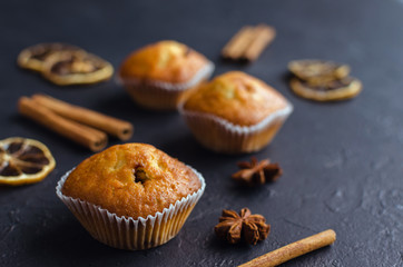Sweet muffins with on dark textured background.