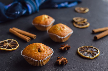 Sweet muffins with on dark textured background.