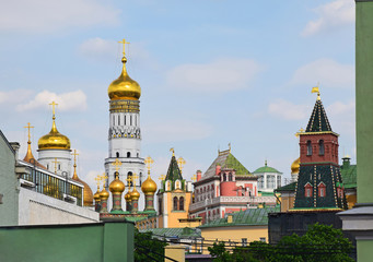 Fototapeta na wymiar View of the domes of the Moscow Kremlin from the roof of a neighboring house. Russia, Moscow, May 2019
