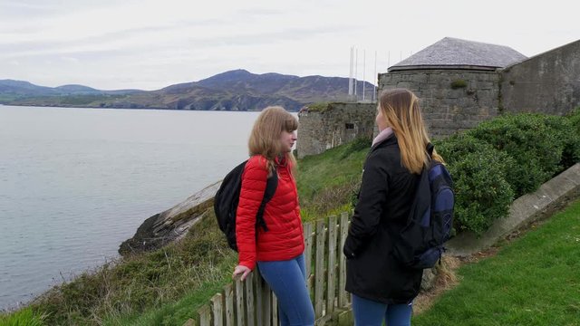 Two friends travel through Ireland at Dunree Head - travel photography