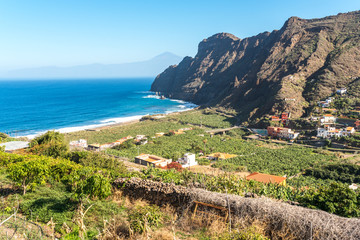 Banana plantations on the coast of Hermigua on La Gomera. The small village lives from tourism and agriculture. In the background, the Pico del Teide on Tenerife.