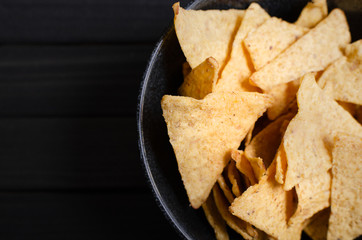 Mexican nachos with sauces on dark background