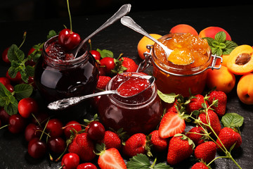 assortment of jams, seasonal berries, apricot, mint and fruits. marmalade or confiture