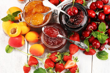 assortment of jams, seasonal berries, apricot, mint and fruits. marmalade or confiture