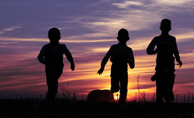 Children running at sunset