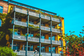 steel balcony on modern brick building with ivy