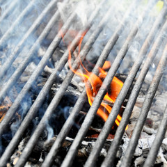 Orange charcoal fire under the grill lattice