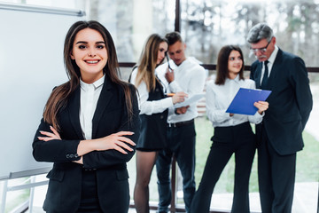 Pretty business woman crossed arms , behind group of manager.. © Тарас Нагирняк