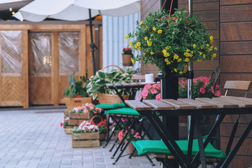 Arrangement of the entrance to the room, tables, flowers and chairs at the entrance to the country house