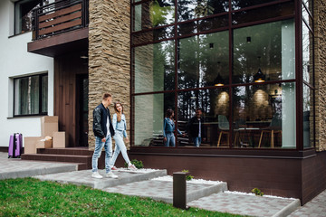 Waking up. Happy young  couple feeling very good while waking up in their big spacious summer house ..Big house..