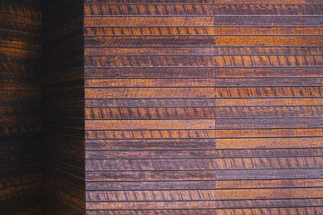 The surface of the wooden dies of dark color in natural lighting, wooden wall