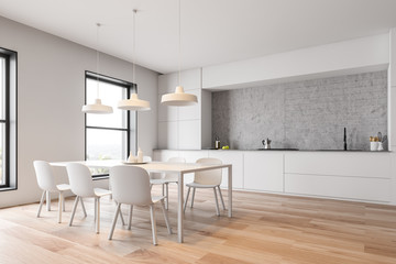 White kitchen corner with countertops and table