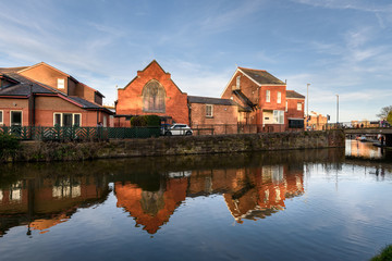 Naklejka na ściany i meble Reflection of houses in River Dee, Chester, UK.
