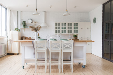 Scandinavian classic kitchen with wooden and white details, minimalistic interior design. Real photo.