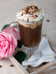 Viennese coffee, real coffee freshly roasted, coffee drink with whipped cream and chocolate chips, lush pink flower