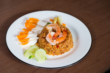 Fried rice chili paste with shrimp and salted eggs and fresh vegetable favorite delicious Thai traditional food on wooden table