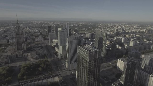 Aerial view of the Warsaw skyline and modern skyscrapers in the business center. Cityscape at sunrise, summer morning. Establishing shot of city metropolis.  Shot on 4k, drone RAW
