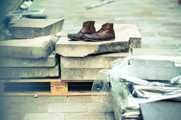 Pair of old boots on the construction site