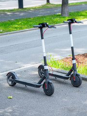 Modern сity transport - Two electric scooters is parked on the street of the city