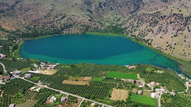 Aerial drone panoramic video of famous natural lake of Kournas with amazing colours and unique nature surrounded by mountains, Chania prefecture, Crete island, Greece