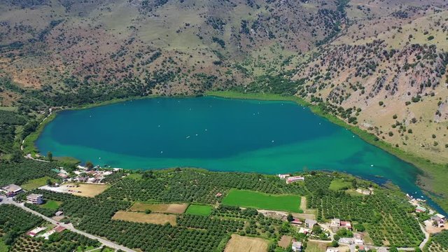 Aerial drone panoramic video of famous natural lake of Kournas with amazing colours and unique nature surrounded by mountains, Chania prefecture, Crete island, Greece