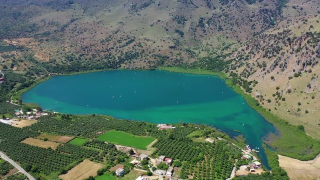 Aerial drone panoramic video of famous natural lake of Kournas with amazing colours and unique nature surrounded by mountains, Chania prefecture, Crete island, Greece
