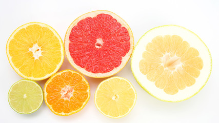Fototapeta na wymiar cut pieces of different citrus fruits on white background