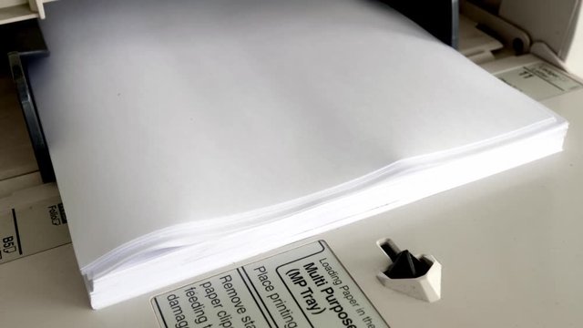 Close Up shot of Office printer document in the process are working and the sheets copier with white paper. 4K, 25fps