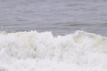 Ocean wave crashing on the beach